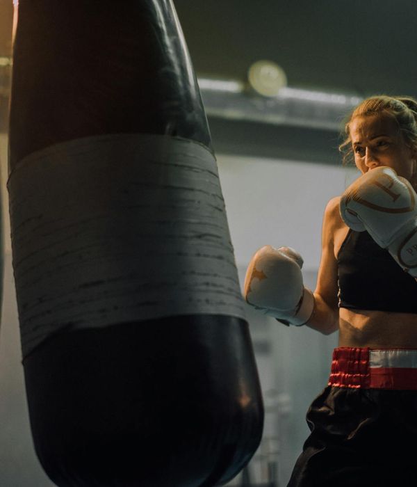 Woman in a calm, focused pose during a low-intensity workout session.